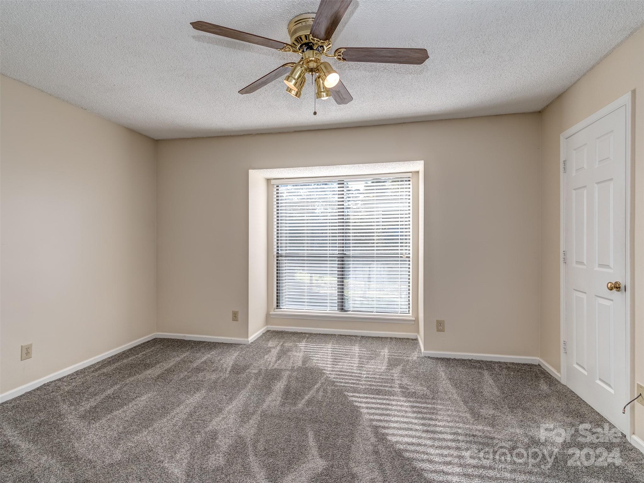 11014 Cedar View Road Charlotte, NC 28226 - Photo 17 of 32 a view of empty room with window and a ceiling fan