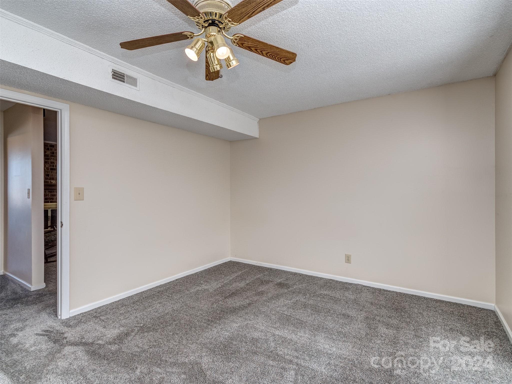 11014 Cedar View Road Charlotte, NC 28226 - Photo 18 of 32 an empty room with a chandelier fan