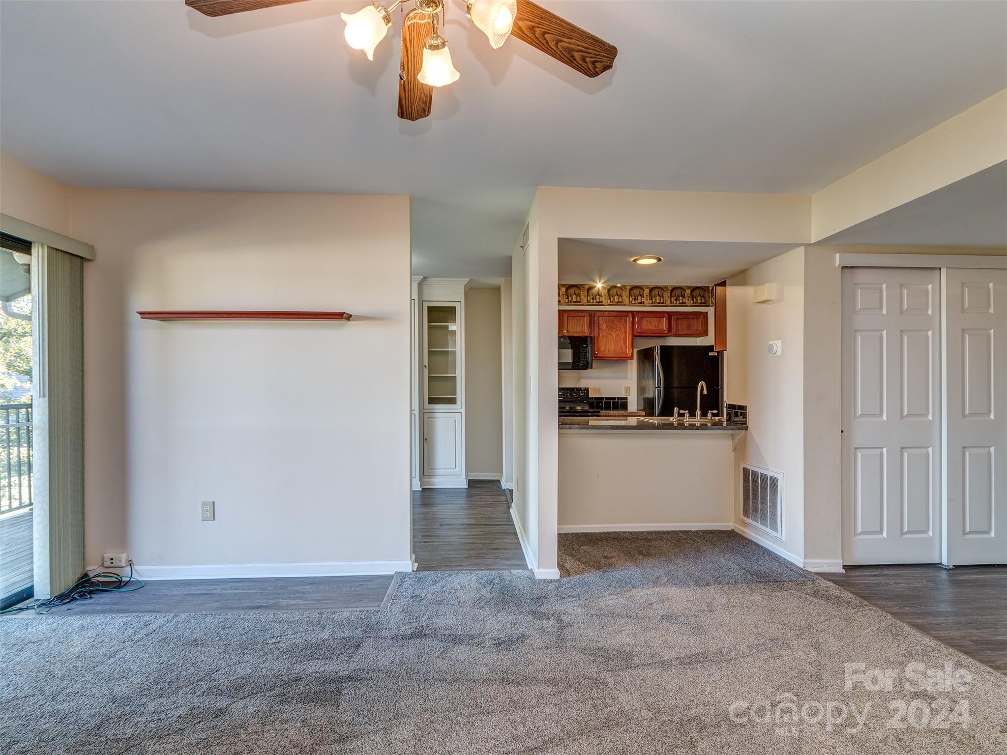 11014 Cedar View Road Charlotte, NC 28226 - Photo 5 of 32 an empty room with kitchen and view of living room