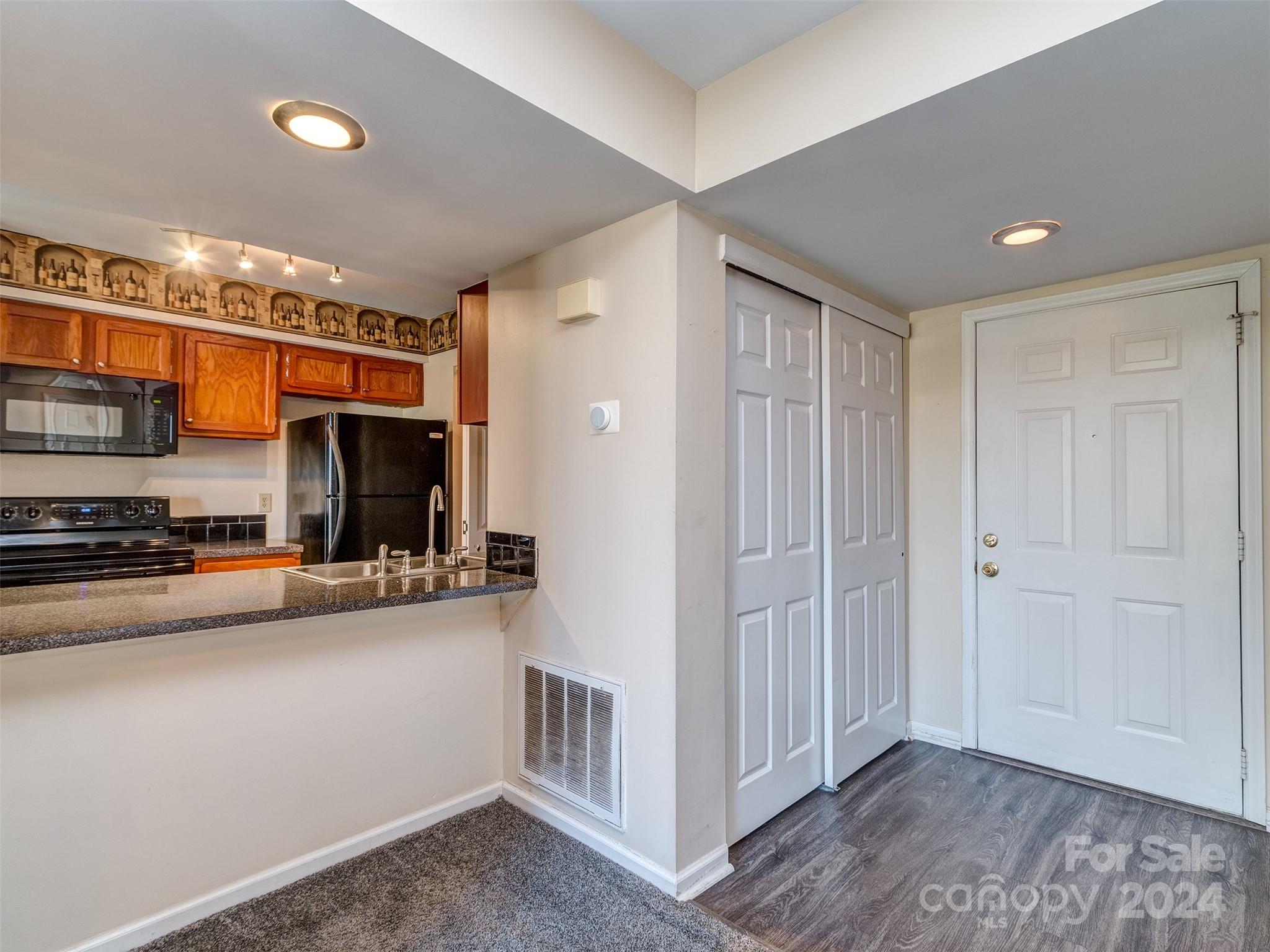 11014 Cedar View Road Charlotte, NC 28226 - Photo 8 of 32 a view of a kitchen with a sink wooden cabinets and entryway