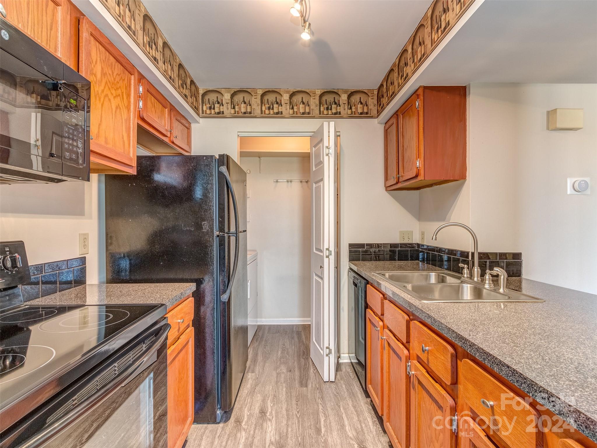 11014 Cedar View Road Charlotte, NC 28226 - Photo 10 of 32 a kitchen with stainless steel appliances granite countertop a sink and a stove top oven