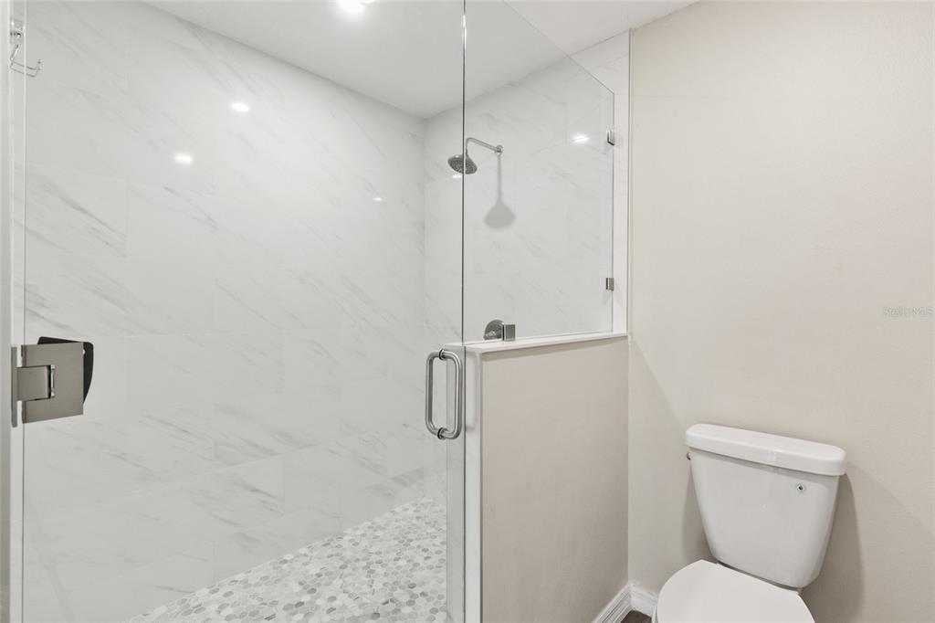 1009 Kings Court Venice, FL 34293 - Photo 11 of 25 a bathroom with a toilet and a shower