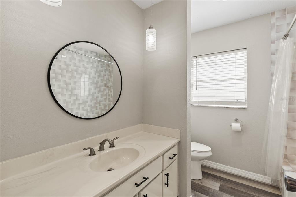 1009 Kings Court Venice, FL 34293 - Photo 14 of 25 a bathroom with a sink and a mirror
