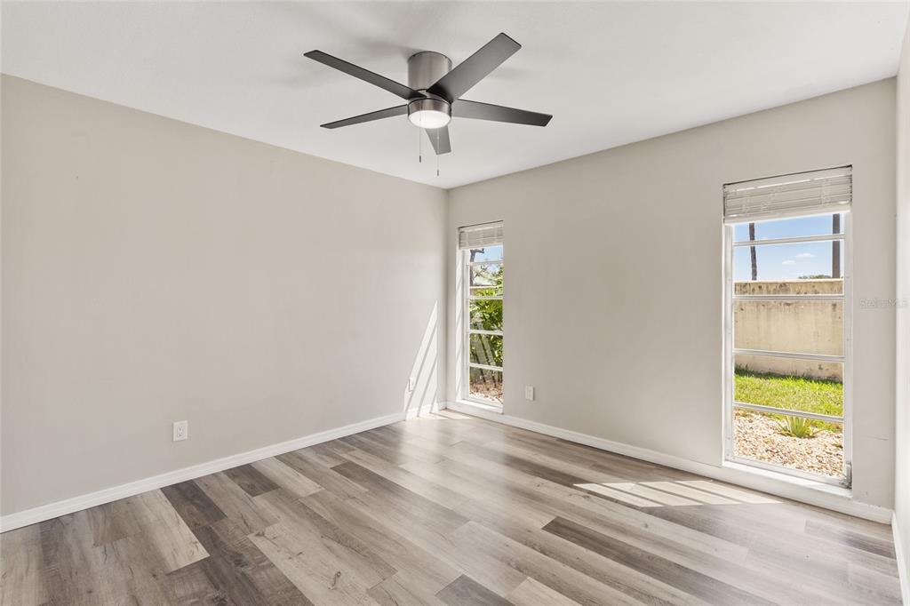 1009 Kings Court Venice, FL 34293 - Photo 15 of 25 wooden floor in an empty room with a window
