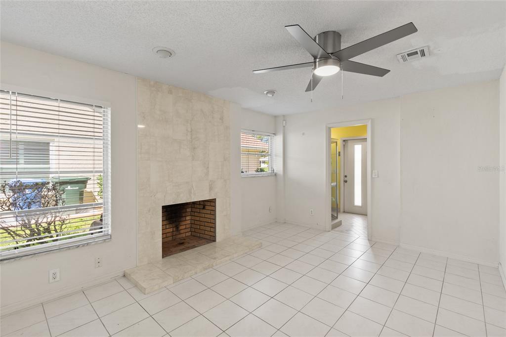 1009 Kings Court Venice, FL 34293 - Photo 16 of 25 a view of an empty room with a window and a kitchen