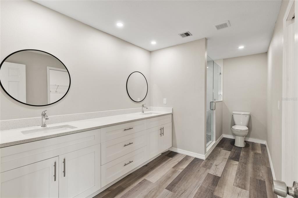 1009 Kings Court Venice, FL 34293 - Photo 10 of 25 a spacious bathroom with a double vanity sink mirror and toilet