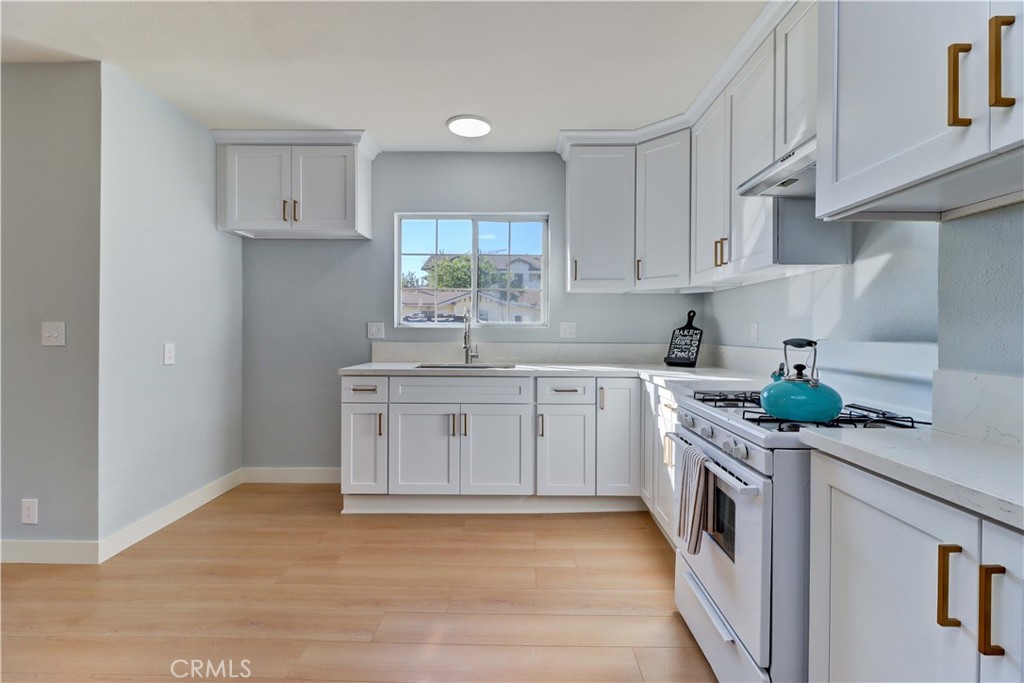 1101 Dawson Avenue Long Beach, CA 90804 - Photo 11 of 26 a kitchen with stainless steel appliances granite countertop a sink and cabinets