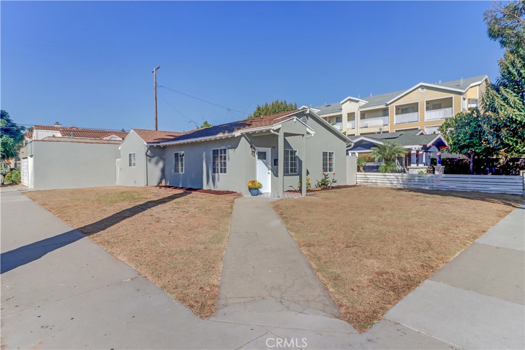 1101 Dawson Avenue Long Beach, CA 90804 - Photo 3 of 26 a view of a white house with a yard and potted plants
