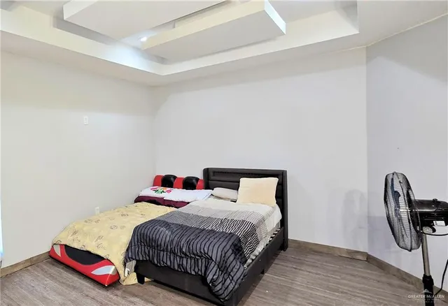 a bedroom with a bed a table and chair