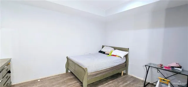 a bedroom with a bed and a chair