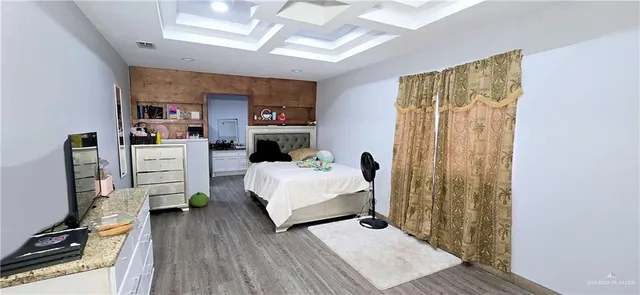 a bedroom with furniture and a wooden floor