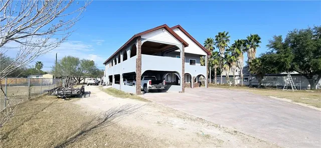 a view of a house with snow in front of house