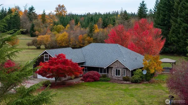 a front view of a house with yard and green space