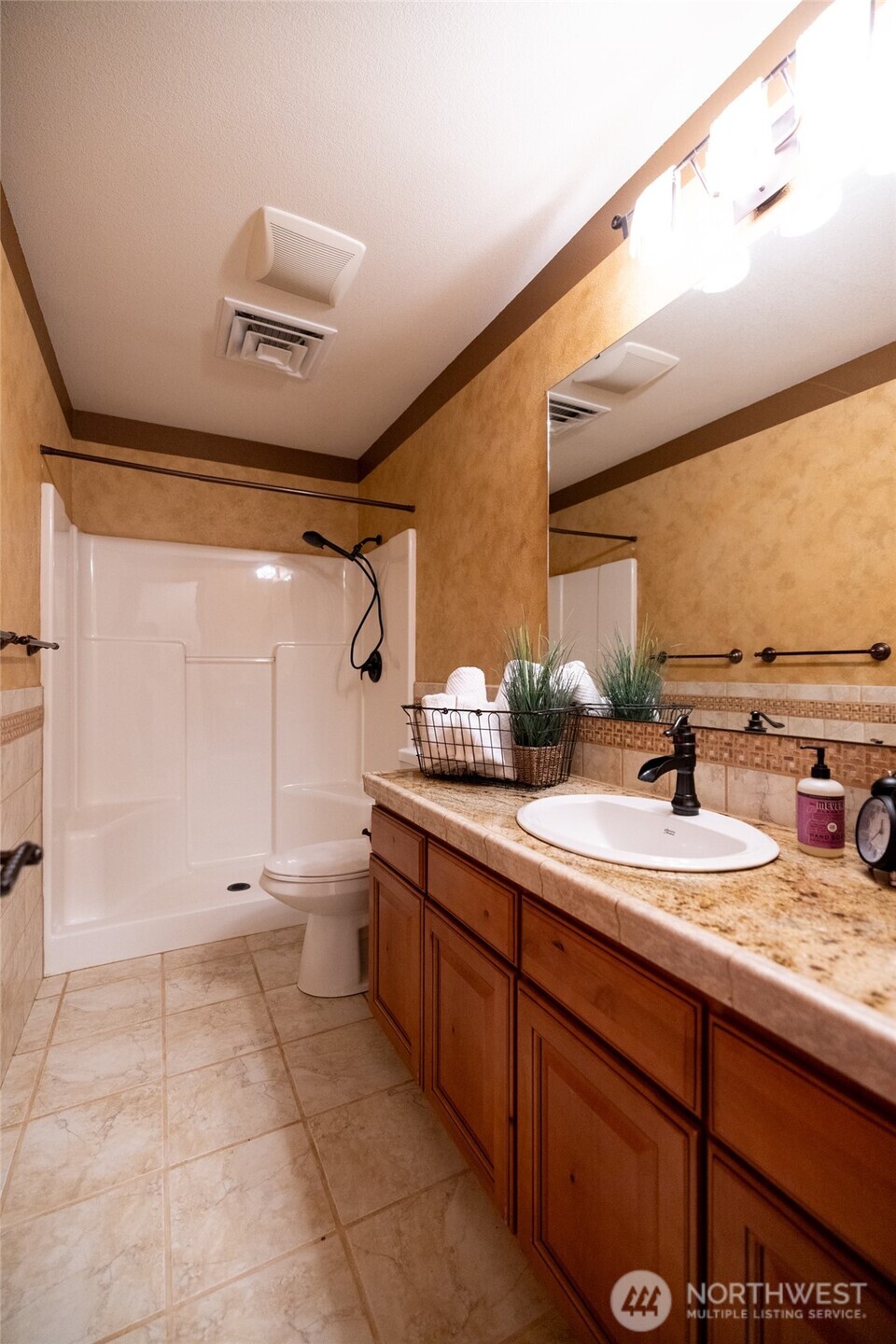 461 East Avery Road, Unit 35 Chehalis, WA 98532 - Photo 37 of 39 a spacious bathroom with a granite countertop sink a toilet and a mirror