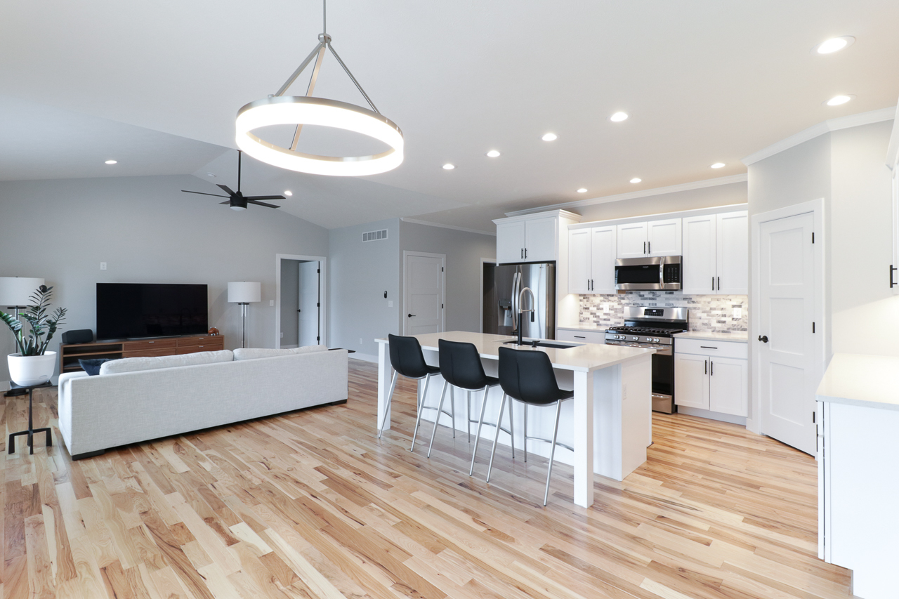 1708 Flagstone Drive Normal, IL 61761 - Photo 11 of 34 a living room with stainless steel appliances kitchen island granite countertop a couch a dining table and chairs with wooden floor