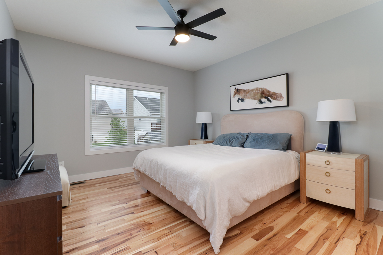 1708 Flagstone Drive Normal, IL 61761 - Photo 14 of 34 a bedroom with a bed and a flat tv screen on dresser