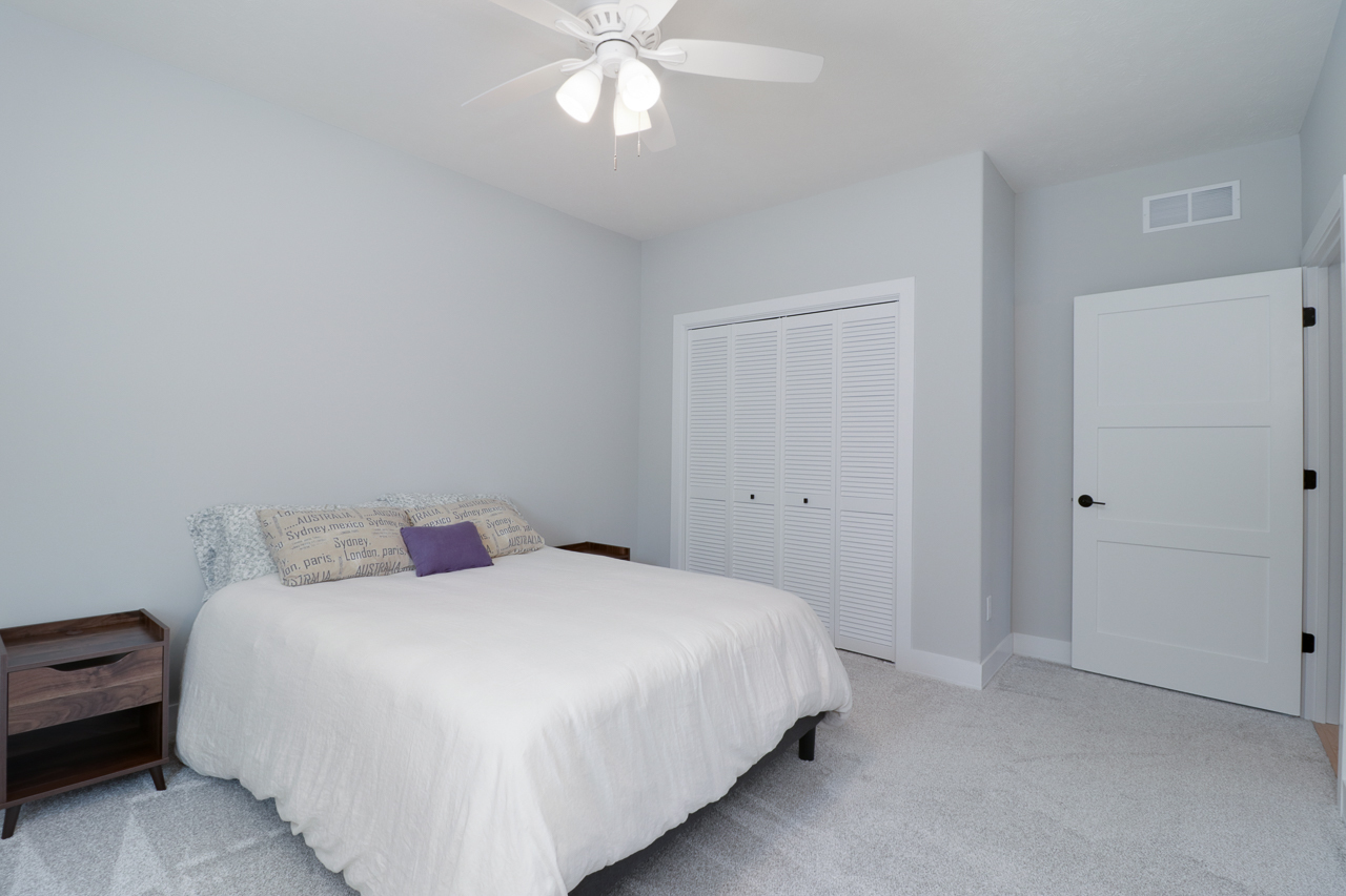 1708 Flagstone Drive Normal, IL 61761 - Photo 21 of 34 a bedroom with a bed and a chandelier