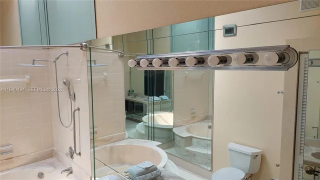 a bathroom with a shower a toilet and a sink