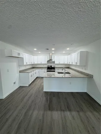 a view of kitchen with wooden floor