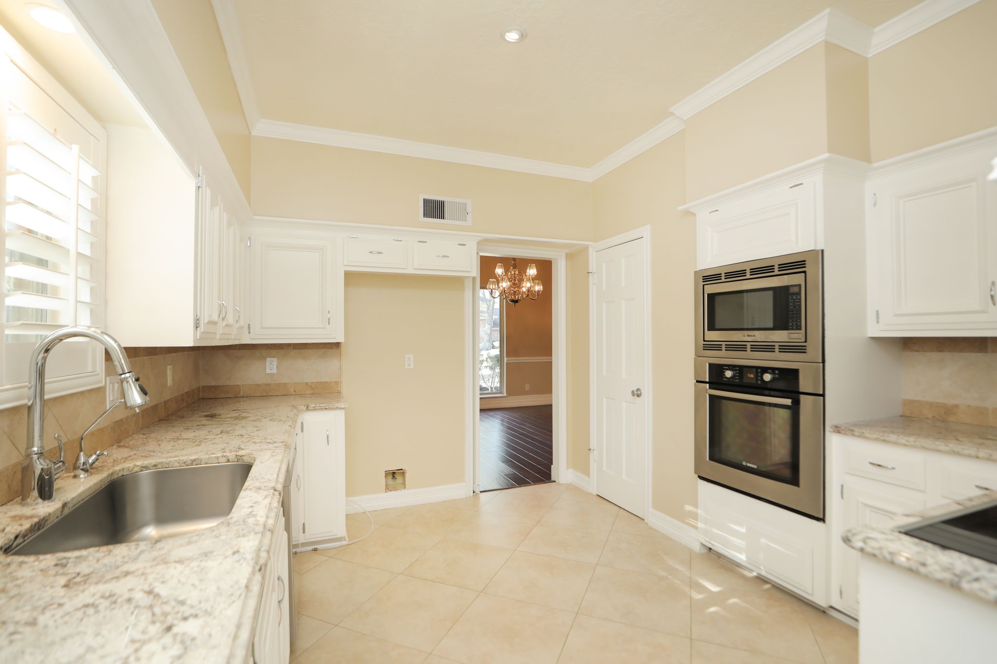 9311 Windrush Drive Spring, TX 77379 - Photo 16 of 50 Cooks delight! Pantry and entrance to dining room on right side, tons of cabinets and sink window.