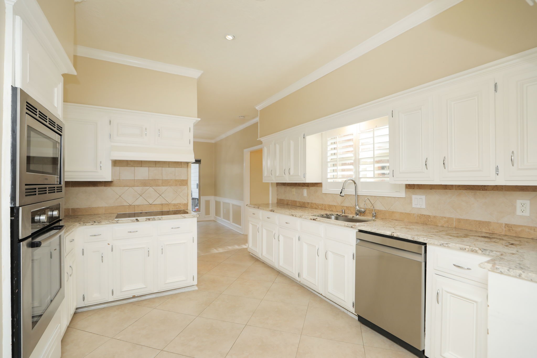 9311 Windrush Drive Spring, TX 77379 - Photo 17 of 50 2nd view kitchen, toward the breakfast room. Stainless appliances and white cabinetry make the room so fresh and light!