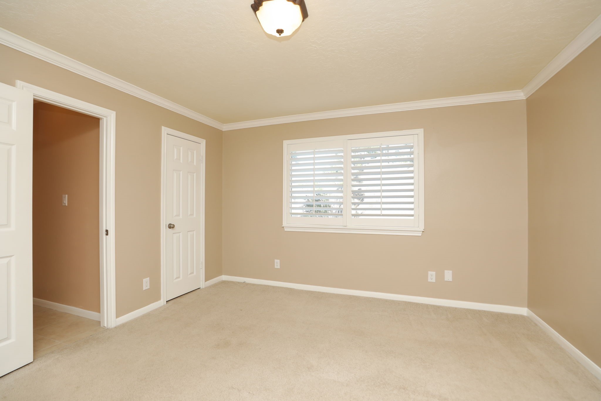 9311 Windrush Drive Spring, TX 77379 - Photo 28 of 50 Bedroom #2 upstairs with crown molding, neutral paint and carpet and double window.