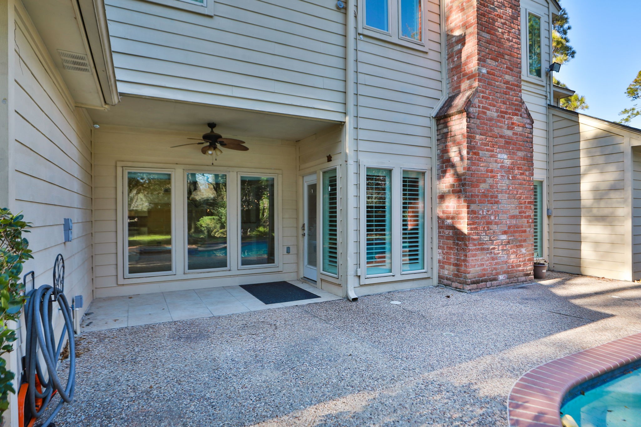 9311 Windrush Drive Spring, TX 77379 - Photo 34 of 50 Covered porch w/ fan and side door leading into living room.