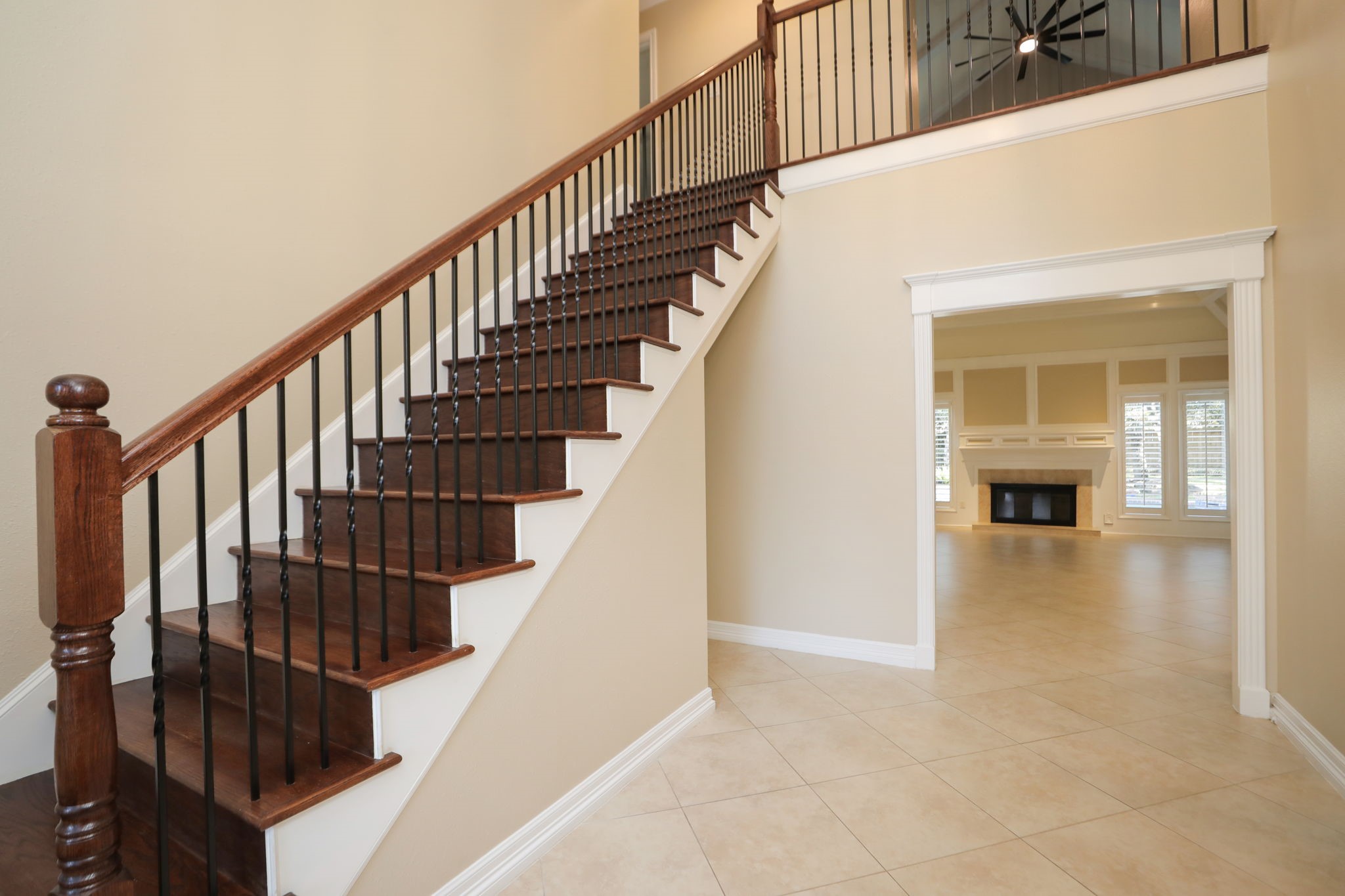 9311 Windrush Drive Spring, TX 77379 - Photo 7 of 50 Gorgeous entrance with 16" Travertine tile flooring, neutral colors, wood & wrought iron staircase and high ceilings.
