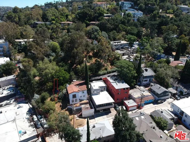 an aerial view of multiple houses with yard
