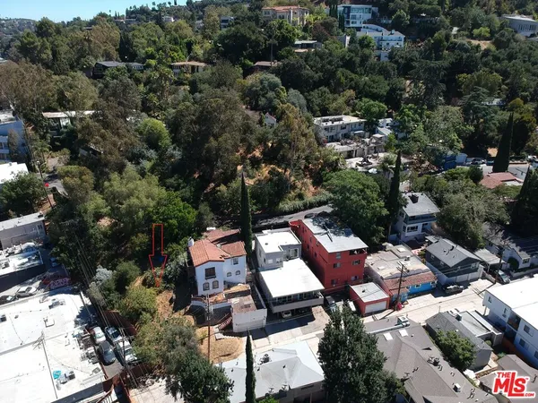 an aerial view of multiple houses with yard