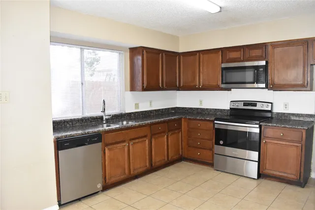 a kitchen with a sink and a stove