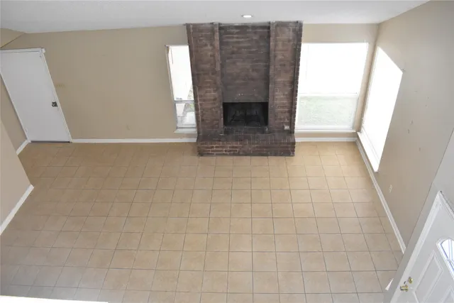 a view of an empty room and fire place