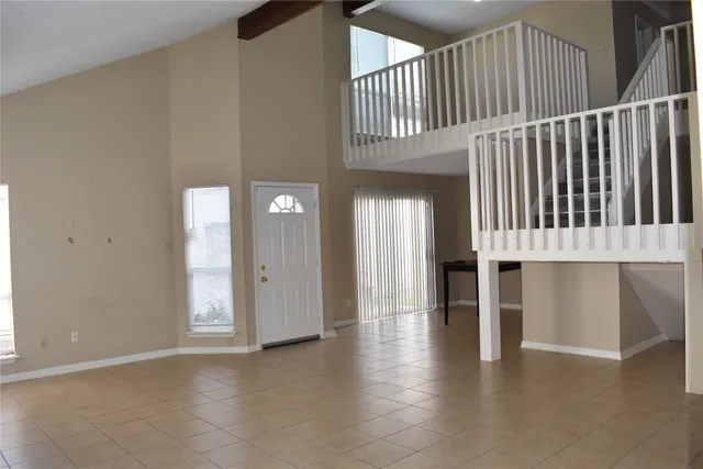 an entryway of a house with wooden floor