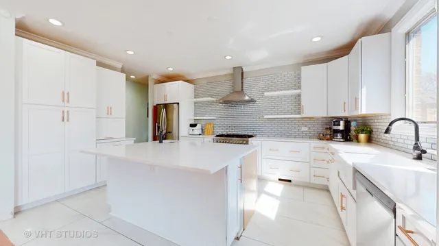 a kitchen with kitchen island a sink appliances and cabinets