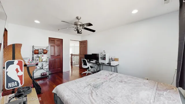 a bedroom with a bed a desk and chair