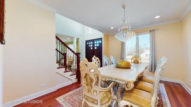 a view of a dining room with furniture and chandelier