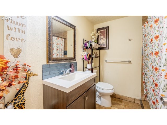 32907 Southwest Acacia Court, Unit 68 Cornelius, OR 97113 - Photo 11 of 15 a bathroom with a sink vanity mirror and toilet