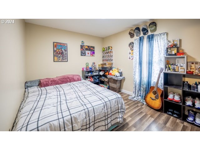 32907 Southwest Acacia Court, Unit 68 Cornelius, OR 97113 - Photo 12 of 15 a bedroom with a bed and a wooden floor