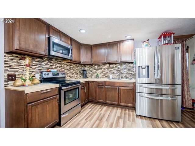 32907 Southwest Acacia Court, Unit 68 Cornelius, OR 97113 - Photo 5 of 15 a kitchen with a sink stove and cabinets