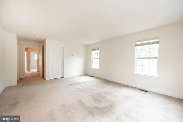 a bathroom with a tub double sink window and mirror
