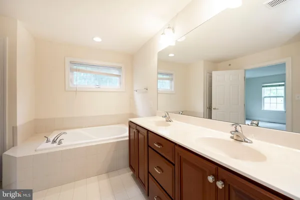 a bathroom with a double vanity sink mirror and double