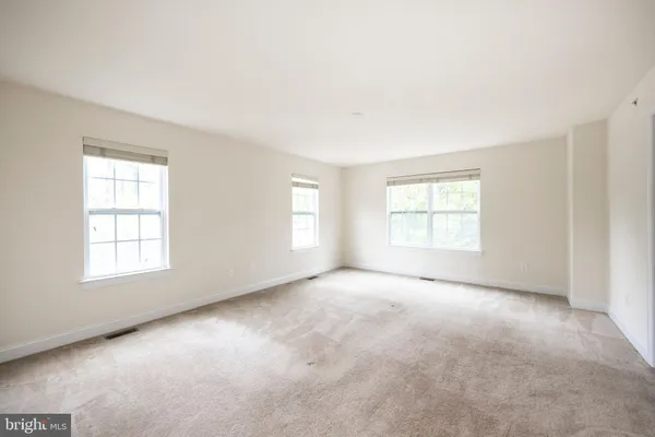 a view of walk in closet with clothes