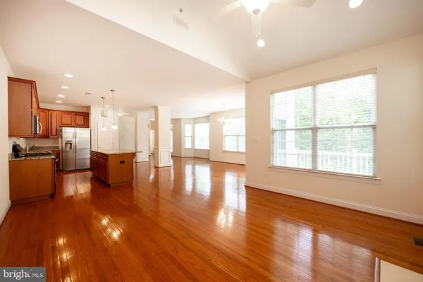 a view of a living room and kitchen with a large window