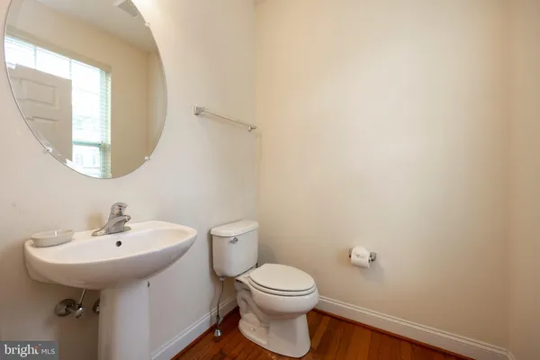 a bathroom with a sink a toilet and mirror