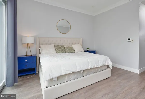 a bedroom with a bed and a large window