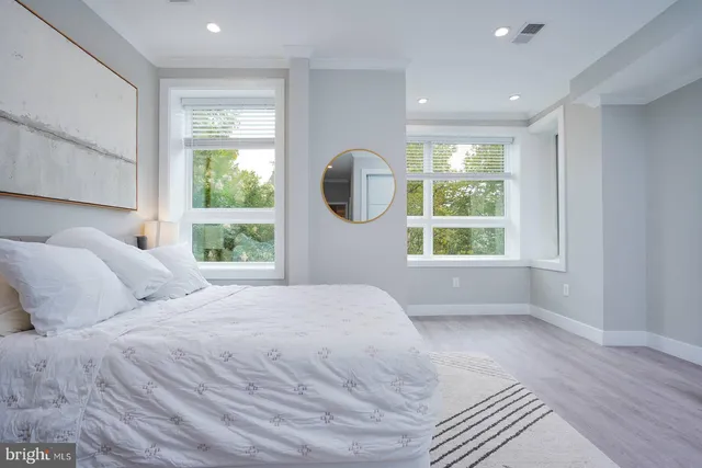 a living room with stainless steel appliances furniture and a kitchen view