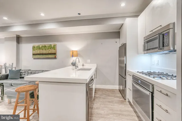 a living room with furniture and a flat screen tv with wooden floor