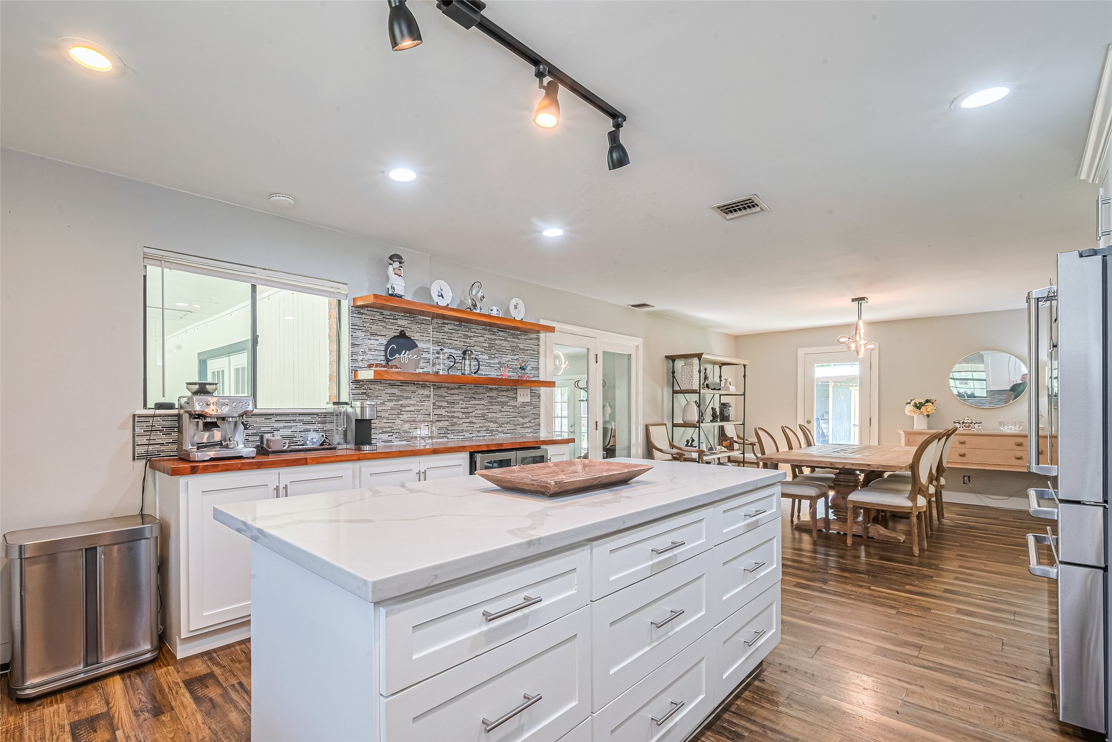 24314 Anderson Street Huffman, TX 77336 - Photo 24 of 48 a view of a kitchen with kitchen island stainless steel appliances a dining table and chairs