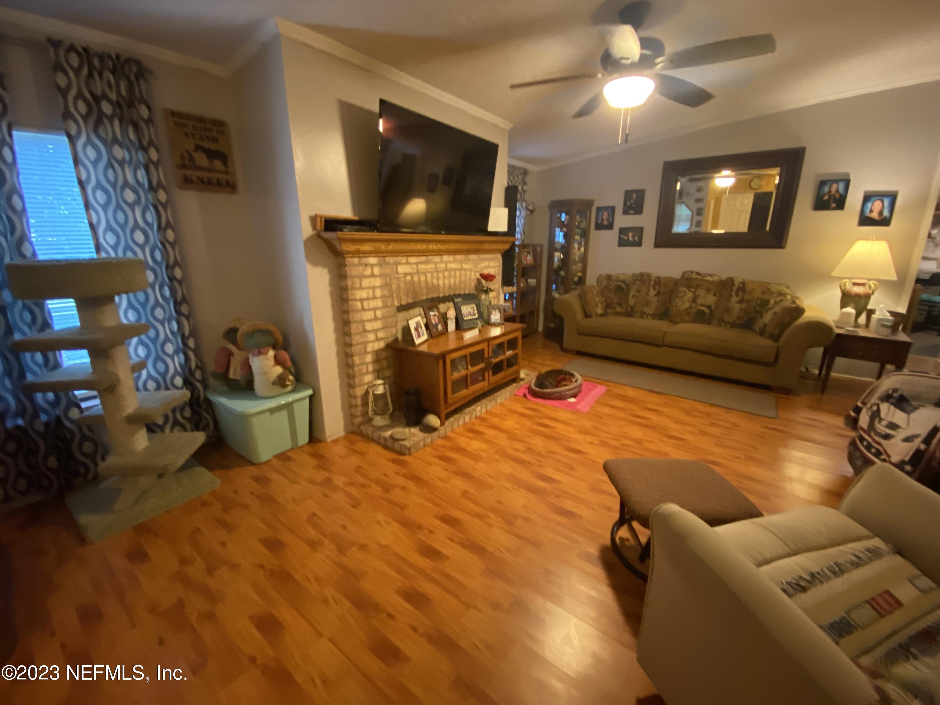 3966 Michaelwood Road Middleburg, FL 32068 - Photo 2 of 17 a bedroom with a bed a couch and television