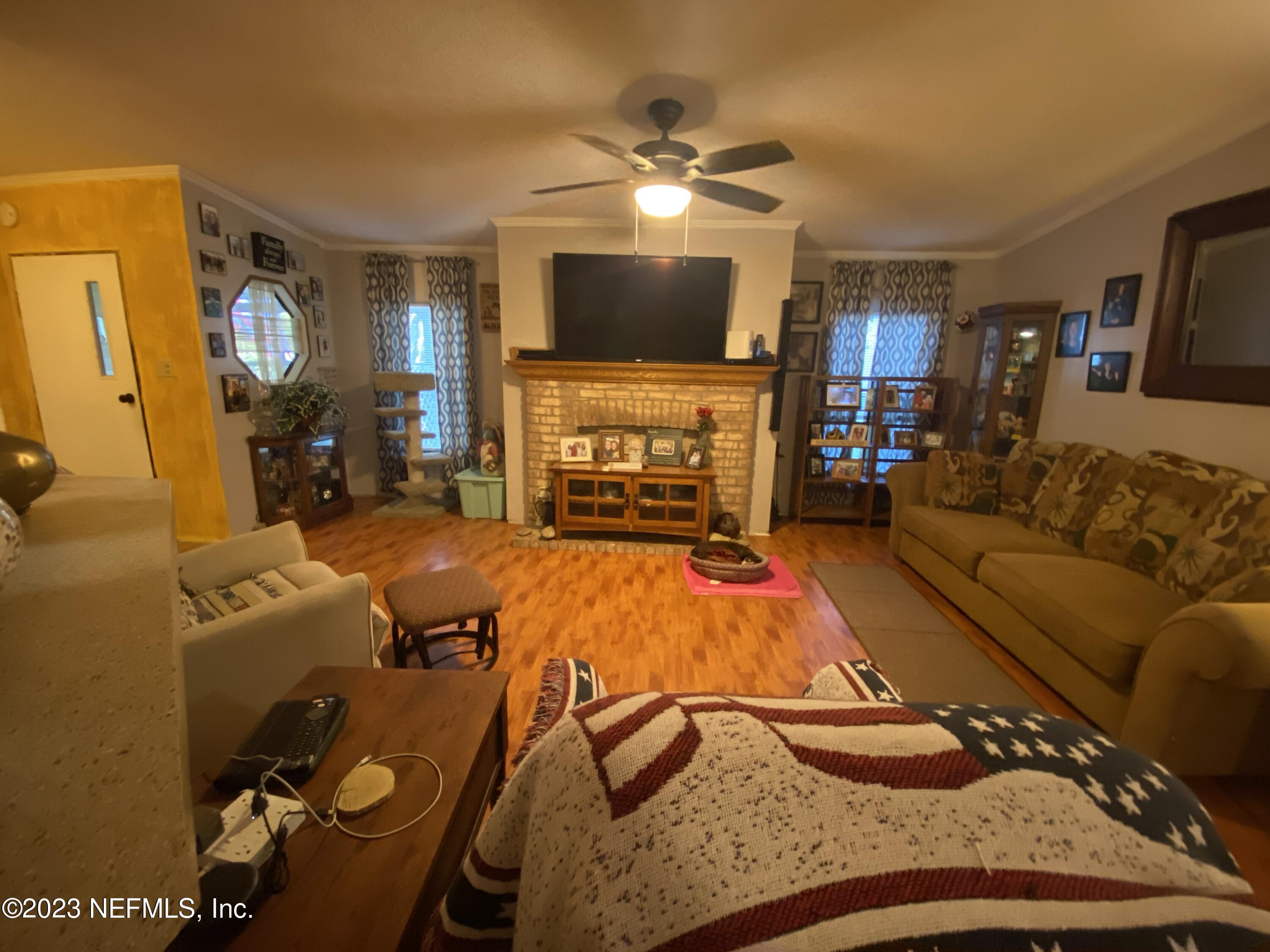 3966 Michaelwood Road Middleburg, FL 32068 - Photo 3 of 17 a living room with furniture and a flat screen tv